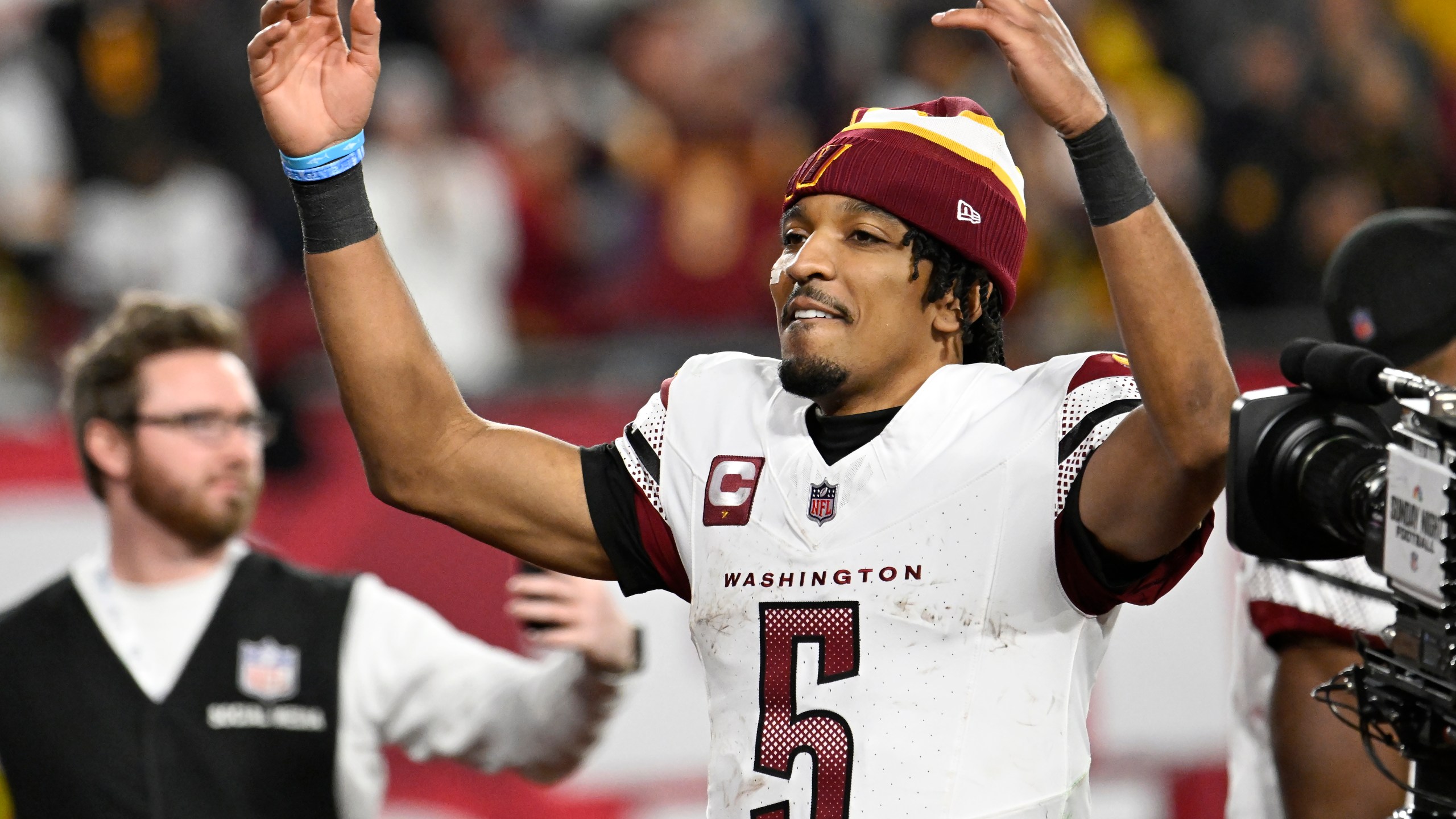 Washington Commanders quarterback Jayden Daniels (5) celebrates after an NFL wild-card playoff football game against the Tampa Bay Buccaneers in Tampa, Fla., Sunday, Jan. 12, 2025. (AP Photo/Jason Behnken)