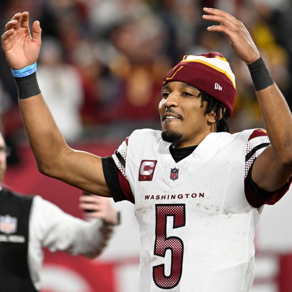 Washington Commanders quarterback Jayden Daniels (5) celebrates after an NFL wild-card playoff football game against the Tampa Bay Buccaneers in Tampa, Fla., Sunday, Jan. 12, 2025. (AP Photo/Jason Behnken)