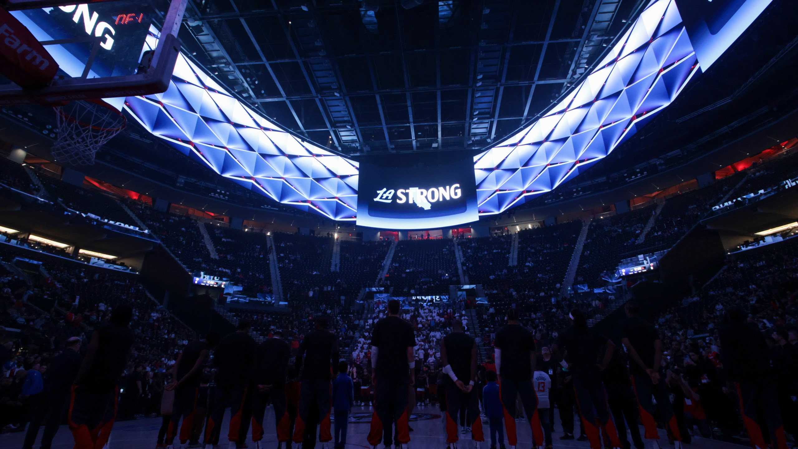 Los Angeles Clippers players stand during a moment of silence for victims of the ongoing California wildfires before an NBA basketball game against the Miami Heat, Monday, Jan. 13, 2025, in Los Angeles. (AP Photo/Jessie Alcheh)