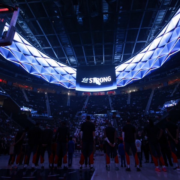 Los Angeles Clippers players stand during a moment of silence for victims of the ongoing California wildfires before an NBA basketball game against the Miami Heat, Monday, Jan. 13, 2025, in Los Angeles. (AP Photo/Jessie Alcheh)