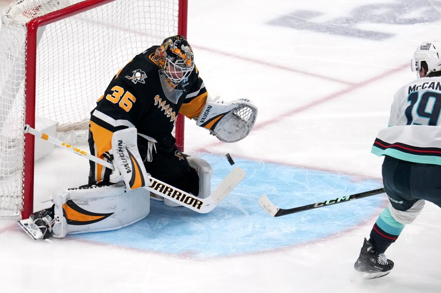 Pittsburgh Penguins goaltender Tristan Jarry blocks a shot by Seattle Kraken's Jared McCann during the first period of an NHL hockey game in Pittsburgh, Tuesday, Jan. 14, 2025. (AP Photo/Gene J. Puskar)