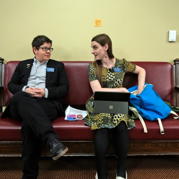 FILE - State Rep. Zooey Zephyr, right, speaks with colleague Rep. SJ Howell after House Speaker Matt Regier told her she could not work from the hallway just outside the main chamber of the House, April 27, 2023 in Helena, Mont. (AP Photo/Brittany Peterson, File)