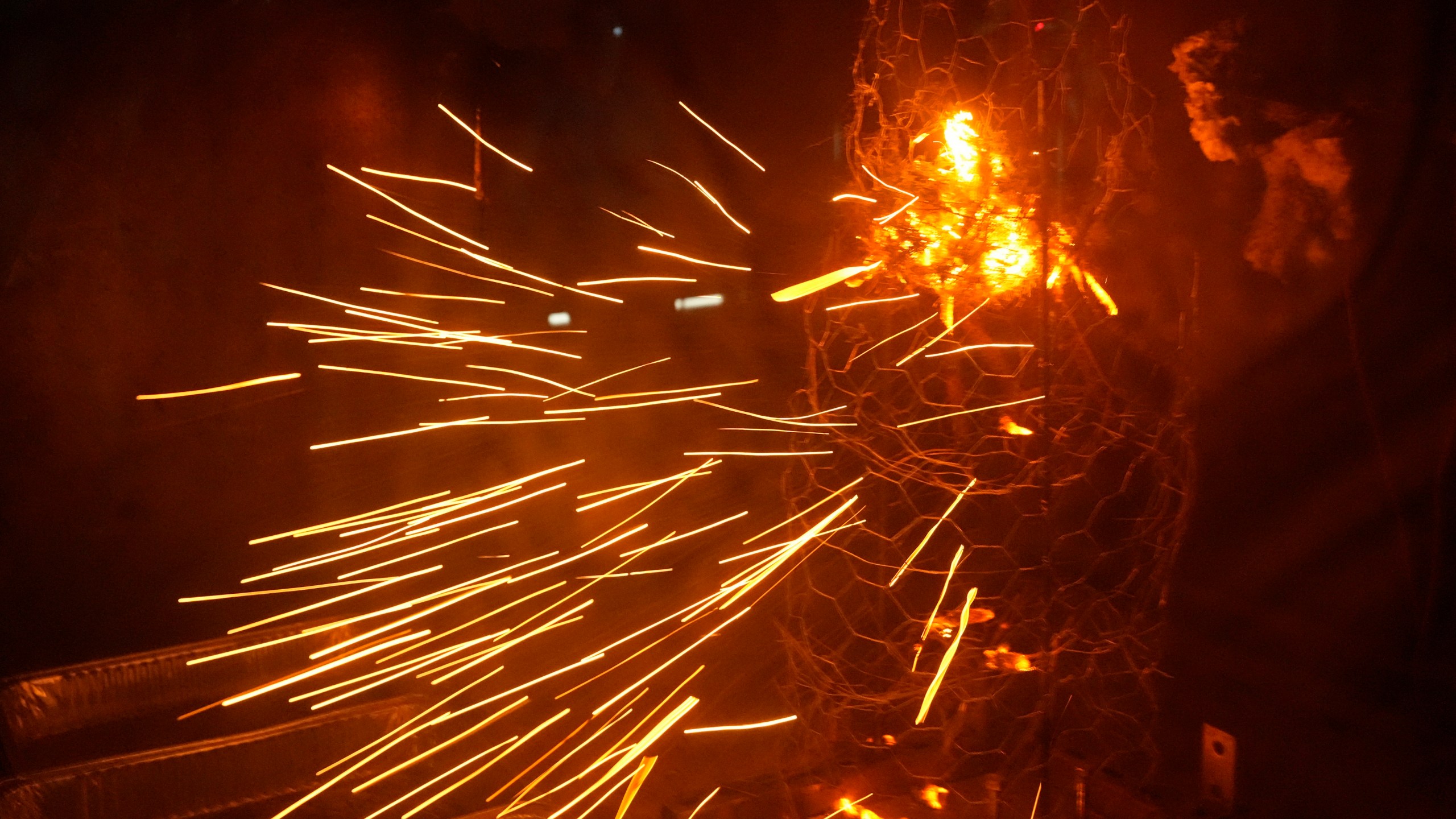 Sparks fly during a controlled burning of brush in a wind tunnel in lab at Worcester Polytechnic Institute, Wednesday, Jan. 15, 2025, in Worcester, Mass. (AP Photo/Robert F. Bukaty)