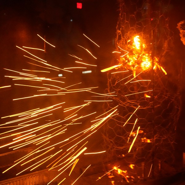 Sparks fly during a controlled burning of brush in a wind tunnel in lab at Worcester Polytechnic Institute, Wednesday, Jan. 15, 2025, in Worcester, Mass. (AP Photo/Robert F. Bukaty)