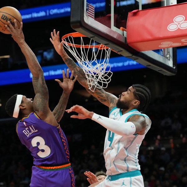 Phoenix Suns guard Bradley Beal (3) goes up to shoot over Charlotte Hornets center Nick Richards (4) during the second half of an NBA basketball game Sunday, Jan. 12, 2025, in Phoenix. (AP Photo/Ross D. Franklin)