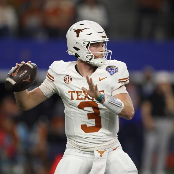 Texas quarterback Quinn Ewers (3) passes against Ohio State during the first half of the Cotton Bowl College Football Playoff semifinal game, Friday, Jan. 10, 2025, in Arlington, Texas. (AP Photo/Gareth Patterson)