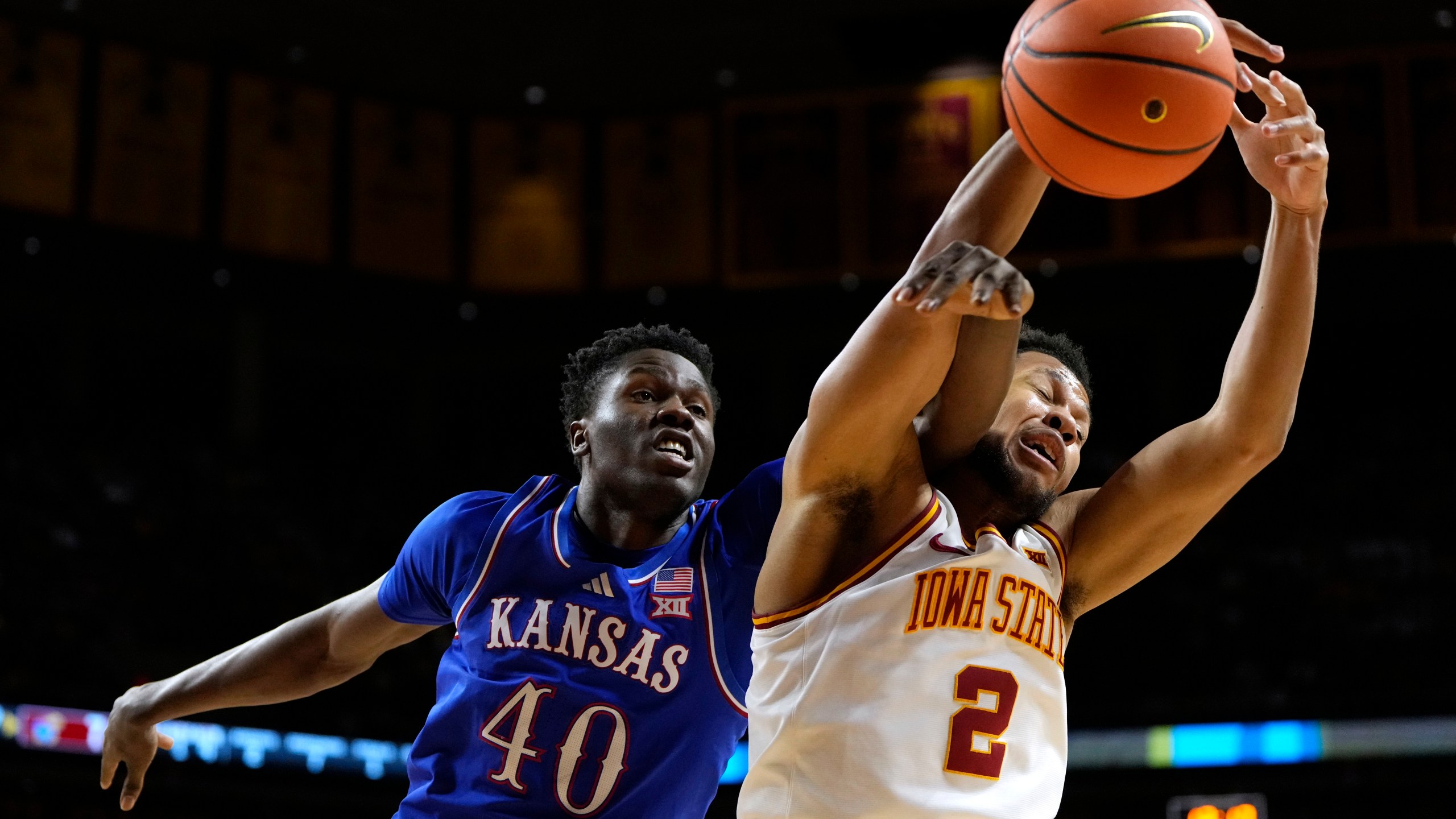 Kansas forward Flory Bidunga (40) fights for a rebound with Iowa State forward Joshua Jefferson (2) during the first half of an NCAA college basketball game, Wednesday, Jan. 15, 2025, in Ames, Iowa. (AP Photo/Charlie Neibergall)