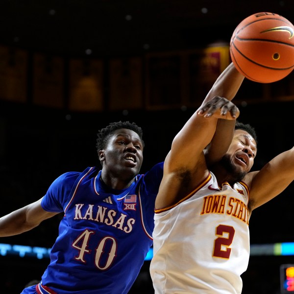 Kansas forward Flory Bidunga (40) fights for a rebound with Iowa State forward Joshua Jefferson (2) during the first half of an NCAA college basketball game, Wednesday, Jan. 15, 2025, in Ames, Iowa. (AP Photo/Charlie Neibergall)