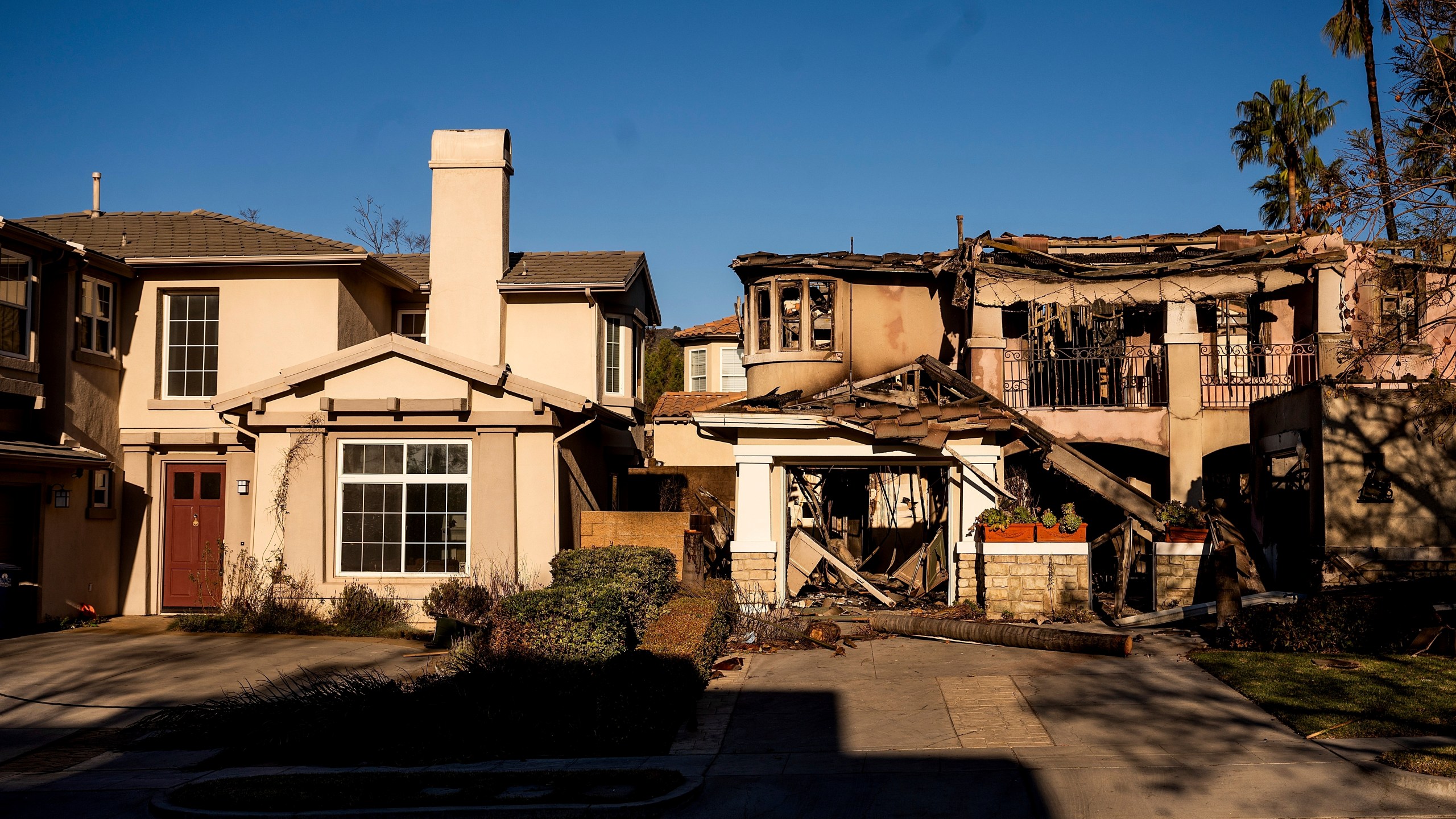 FILE - A home destroyed by the Eaton Fire, right, stands next a home that survived in Altadena. Calif., on Monday, Jan. 13, 2025. (AP Photo/Noah Berger, File)