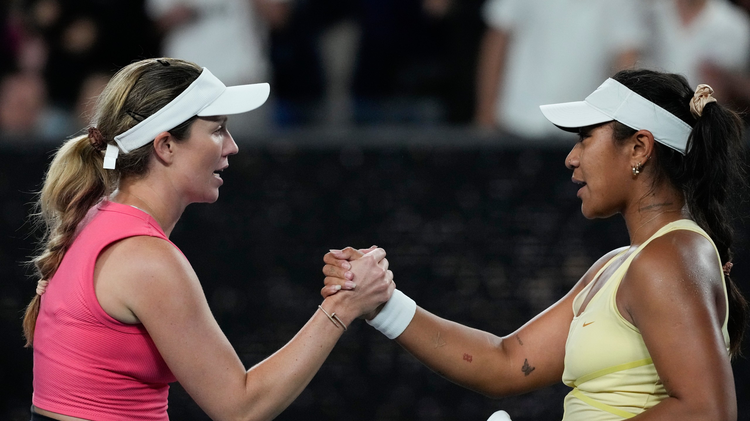 Danielle Collins, left, of the U.S. is congratulated by Destanee Aiava of Australia following their second round match at the Australian Open tennis championship in Melbourne, Australia, Thursday, Jan. 16, 2025. (AP Photo/Manish Swarup)