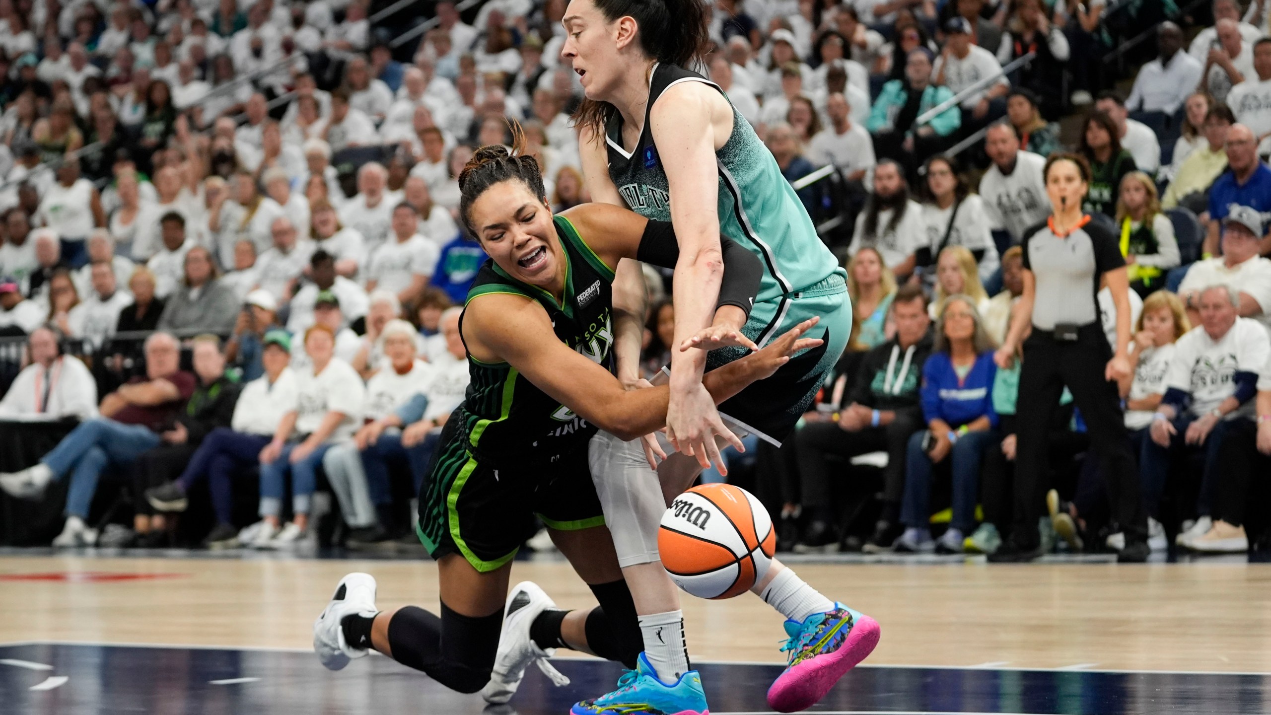 FILE -Minnesota Lynx forward Napheesa Collier and New York Liberty forward Breanna Stewart, right, battle for a loose ball during the second half of Game 4 of a WNBA basketball final playoff series, Oct. 18, 2024, in Minneapolis. (AP Photo/Abbie Parr, File)