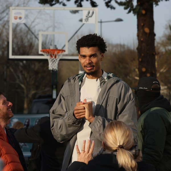 San Antonio Spurs' Victor Wembanyama meets residents as he inaugurates a basketball court, Tuesday, Jan. 21, 2025 in Le Chesnay-Rocquencourt, south of Paris. (AP Photo/Thomas Padilla)