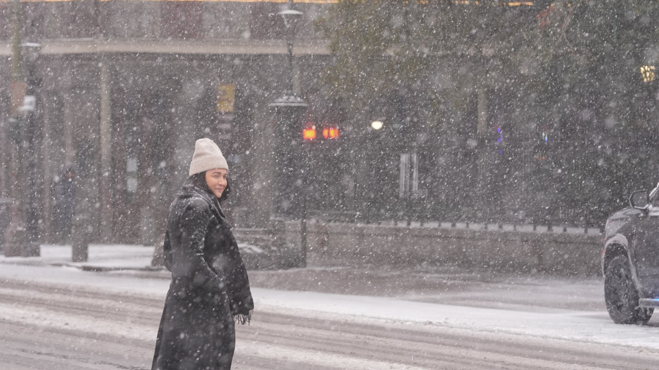 A person walks to Jackson Square as snow falls in the French Quarter in New Orleans, Tuesday, Jan. 21, 2025. (AP Photo/Gerald Herbert)