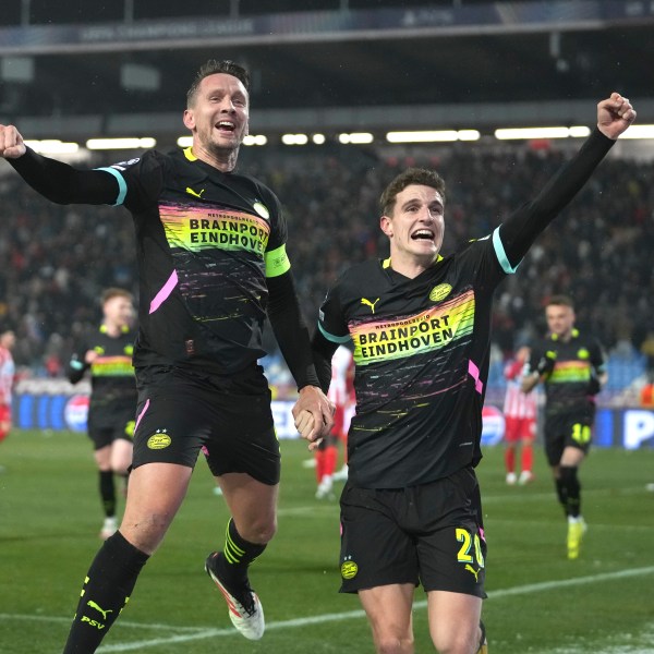 PSV's Luuk de Jong, centre, celebrates with PSV's Guus Til after scoring his side's second goal during the Champions League opening phase soccer match between Red Star and PSV at the Rajko Mitic Stadium in Belgrade, Serbia, Tuesday, Jan. 21, 2025. (AP Photo/Darko Vojinovic)