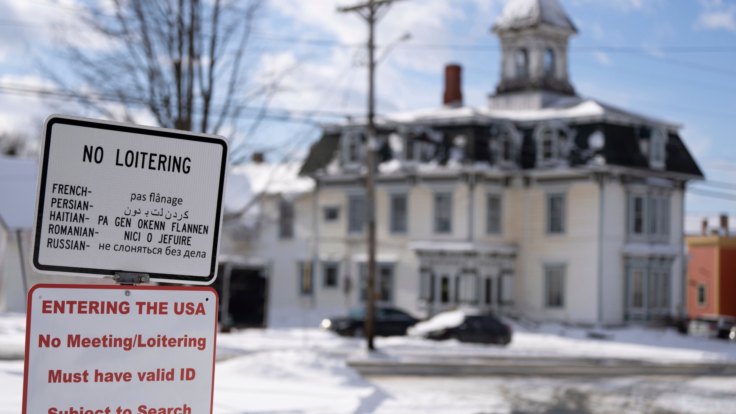 A sign on an unpatrolled border street entering into Derby Line, Vermont, U.S.A., from Stanstead, Quebec, Tuesday, Jan. 21, 2025. (Christinne Muschi/The Canadian Press via AP)