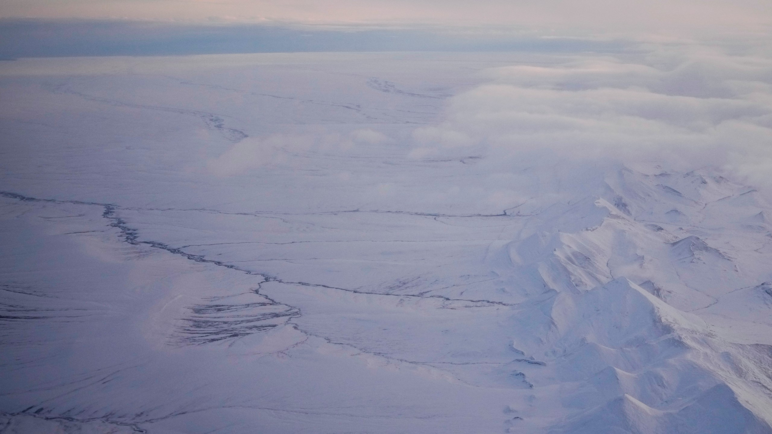 FILE - The snow-covered coastal plain area of the Arctic National Wildlife Refuge is seen, with the Brooks Range at right, Monday, Oct. 14, 2024, near Kaktovik, Alaska. (AP Photo/Lindsey Wasson)