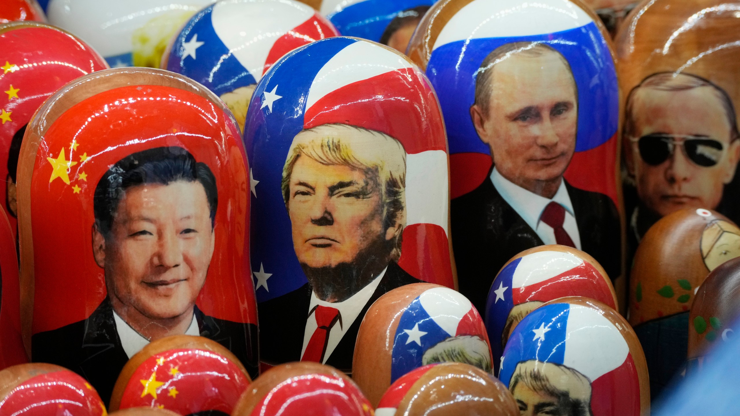 FILE - Traditional Russian wooden dolls called Matryoshka depicting China's President Xi Jinping, U.S. President-elect Donald Trump and Russian President Vladimir Putin are displayed for sale at a souvenir shop in St. Petersburg, Russia on Nov. 21, 2024. (AP Photo/Dmitri Lovetsky, File)