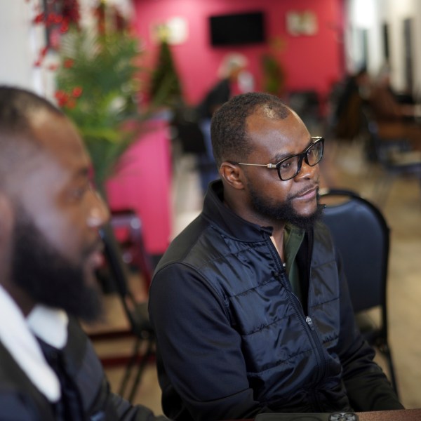 Viles Dorsainvil, executive director of the Haitian Community Help and Support Center at Rose Goute Creole Restaurant, sits with interpreter James Fleurijean, left, a board member of the Haitian Community Help and Support Center, in Springfield, Ohio, Saturday, January 25, 2025. (AP Photo/Jessie Wardarski)