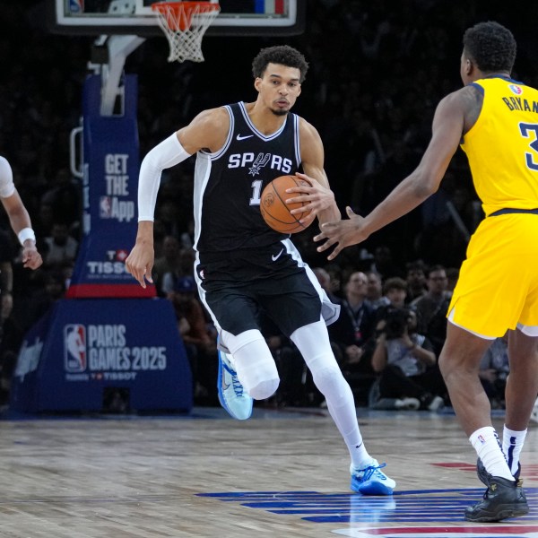 San Antonio Spurs center Victor Wembanyama (1) brings the ball up court under pressure from Indiana Pacers center Thomas Bryant (3) during the second half of a Paris Games 2025 NBA basketball game in Paris, Saturday, Jan. 25, 2025. (AP Photo/Thibault Camus)