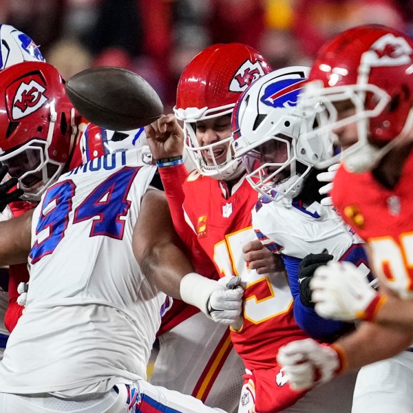 Buffalo Bills defensive end Dawuane Smoot (94) hits Kansas City Chiefs quarterback Patrick Mahomes (15) during the first half of the AFC Championship NFL football game, Sunday, Jan. 26, 2025, in Kansas City, Mo. (AP Photo/Ashley Landis)