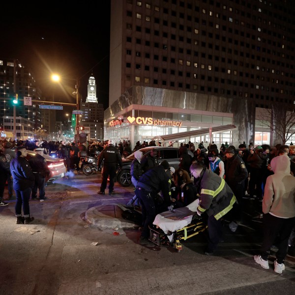 Police and emergency personnel assist multiple people who were struck by a car, at Broad and Spring Garden Street, while celebrating after the Eagles won the Washington Commanders vs. Philadelphia Eagles NFC Championship game in Philadelphia on Sunday, Jan. 26, 2025. ( (Elizabeth Robertson/The Philadelphia Inquirer via AP)