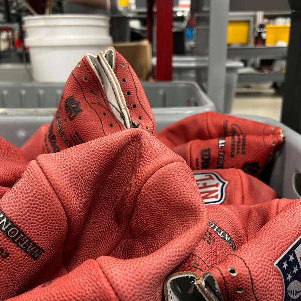 A bin of official balls for the NFL Super Bowl football game wait to be finished inside the Wilson Sporting Goods football factory, Monday, January 27, 2025, in Ada, Ohio. (AP Photo/Patrick Aftoora-Orsagos)