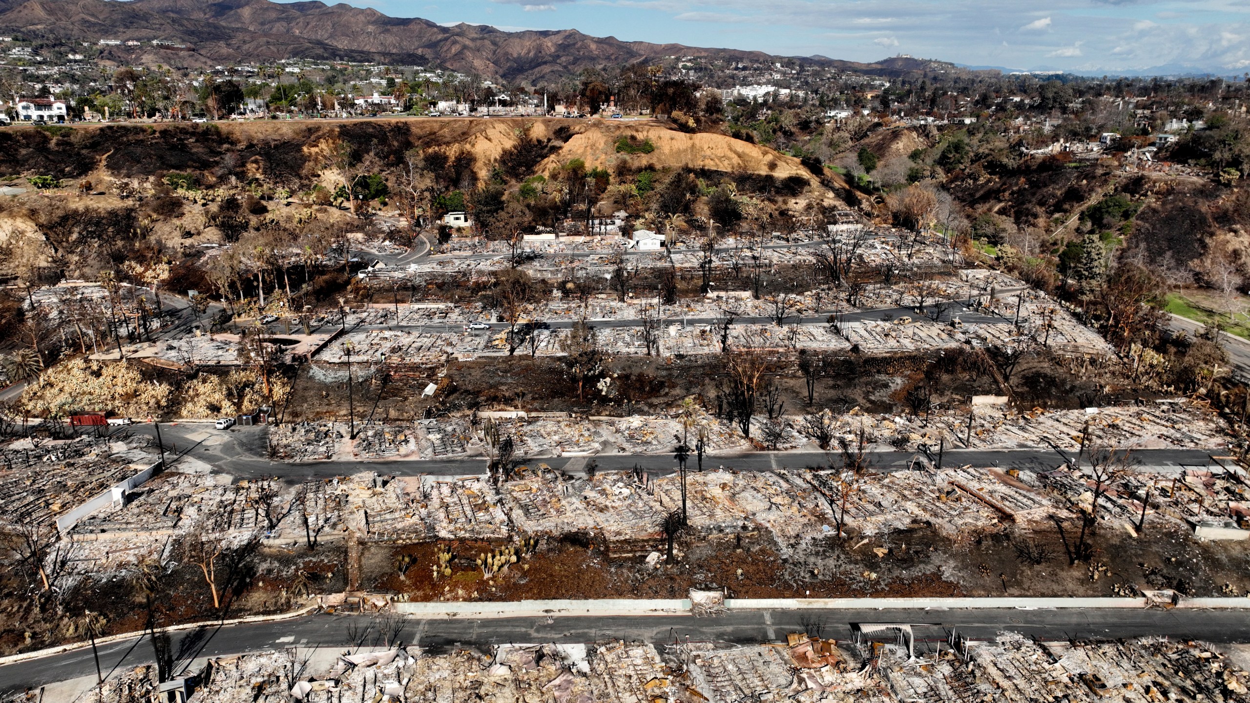 An aerial view shows the devastation left by the Palisades Fire in the Pacific Palisades section of Los Angeles, Monday, Jan. 27, 2025. (AP Photo/Jae C. Hong)