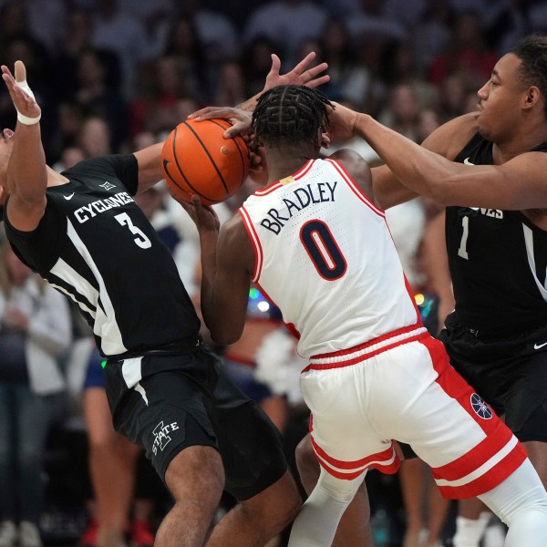 Iowa State guard Tamin Lipsey (3) and center Dishon Jackson (1) pressure Arizona guard Jaden Bradley (0) during the first half of an NCAA college basketball game, Monday, Jan. 27, 2025, in Tucson, Ariz. (AP Photo/Rick Scuteri)