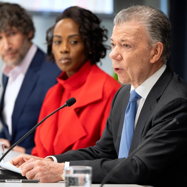 Former Colombian President Juan Manuel Santos, right, speaks as Bulletin of the Atomic Scientists members Daniel Holz, left, and Suzet McKinney listen during a news conference to announce the latest adjustment to the Doomsday Clock of the Bulletin of the Atomic Scientists, currently set at 89 seconds to midnight, at the United States Institute of Peace, Tuesday, Jan. 28, 2025, in Washington. (AP Photo/Mark Schiefelbein)