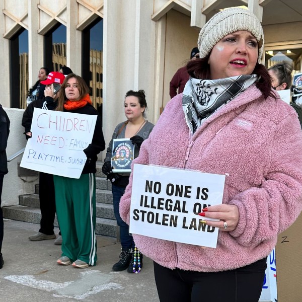 Erica Watkins of Tulsa, state director of Defense of Democracy holds a sign to protest Oklahoma's Board of Education considering a rule that would require parents enrolling children in public schools to provide proof of their child's U.S. citizenship or legal immigration status on Tuesday, Jan. 28, 2025 in Oklahoma City. (AP Photo/Sean Murphy)