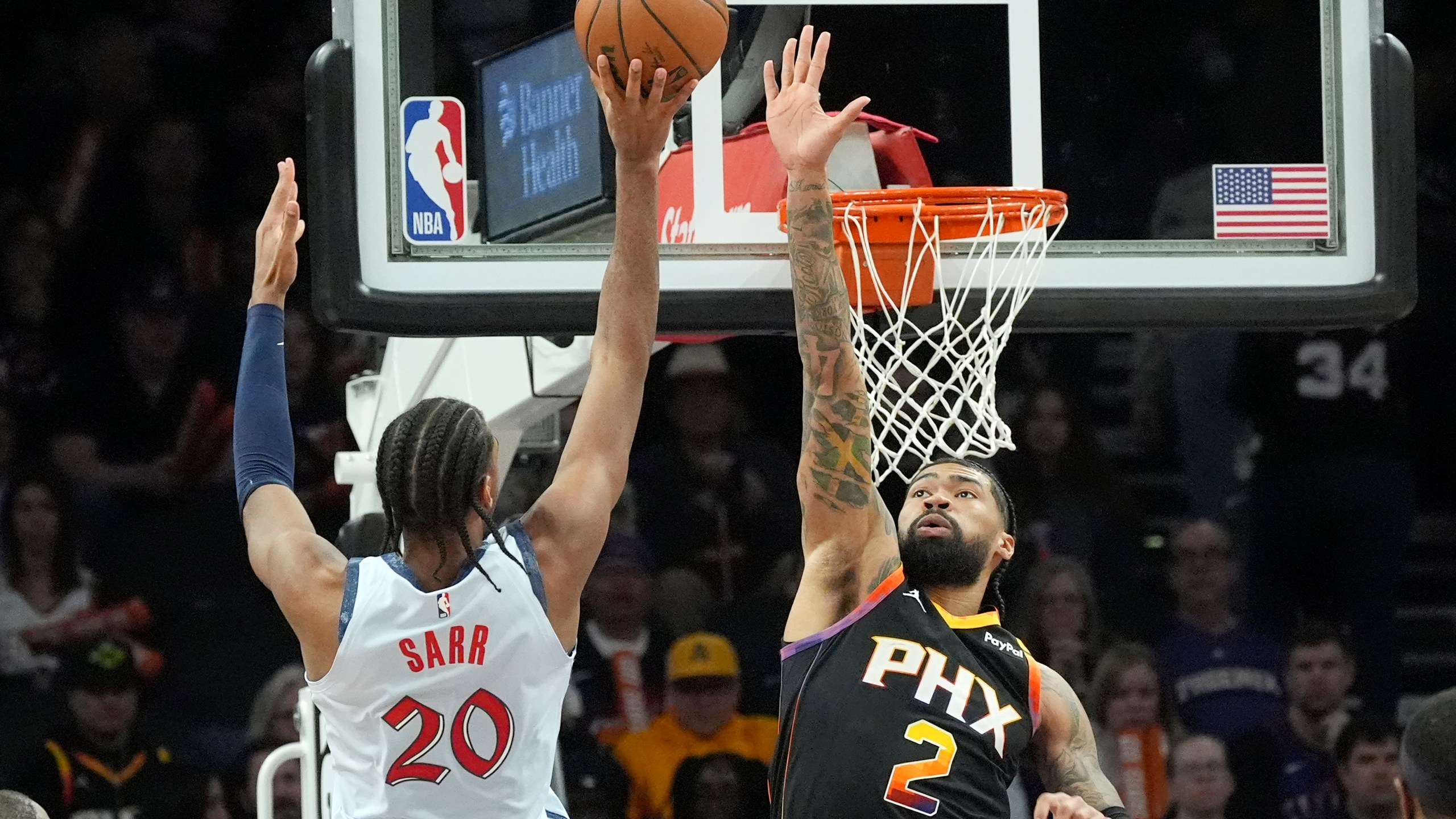 Washington Wizards forward Alex Sarr (20) tries to shoot over Phoenix Suns center Nick Richards (2) during the second half of an NBA basketball game Saturday, Jan. 25, 2025, in Phoenix. (AP Photo/Ross D. Franklin)