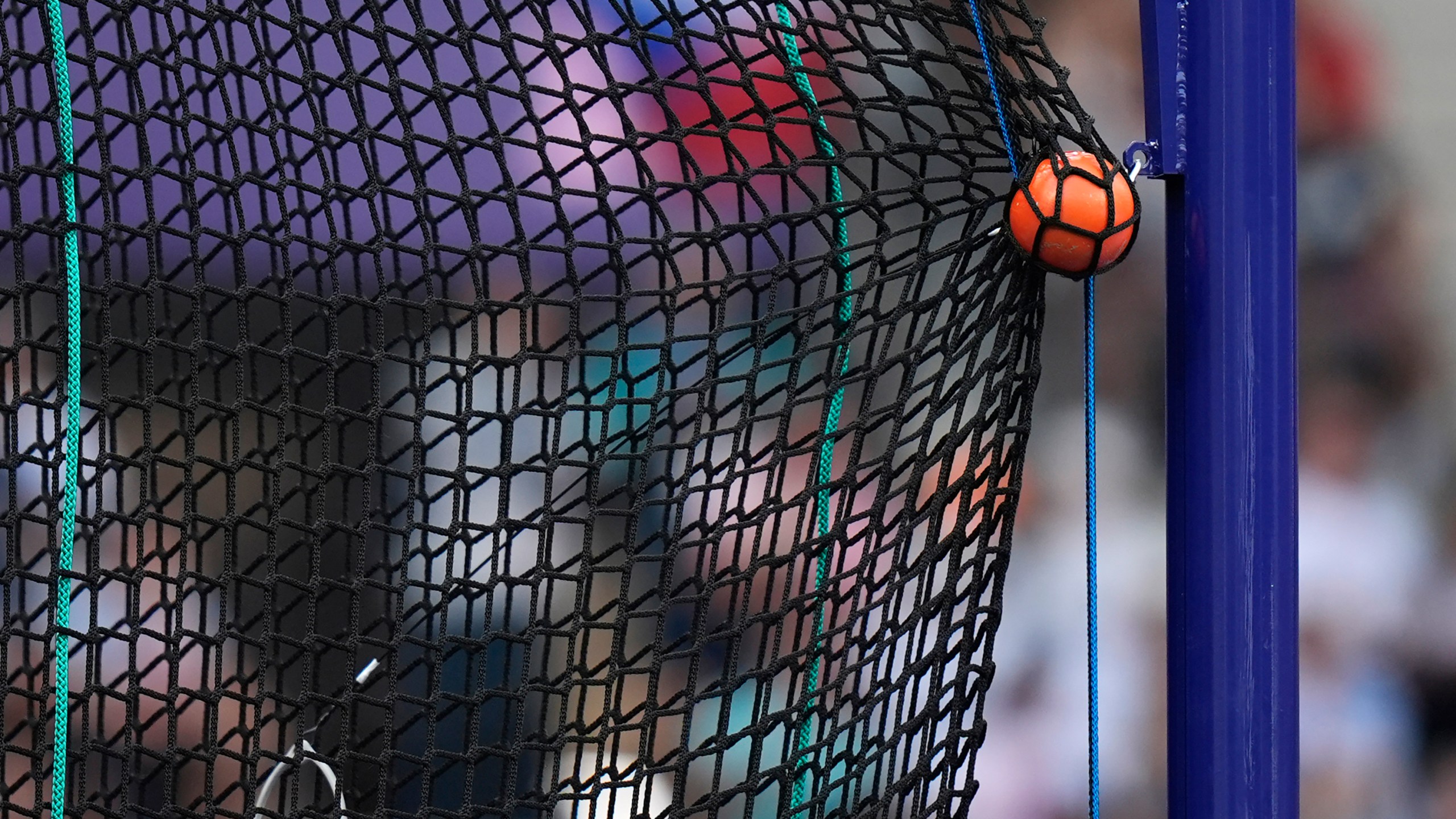 FILE - A hammer is caught by the safety net during the men's hammer throw qualification at the 2024 Summer Olympics, Aug. 2, 2024, in Saint-Denis, France. (AP Photo/Matthias Schrader, File)