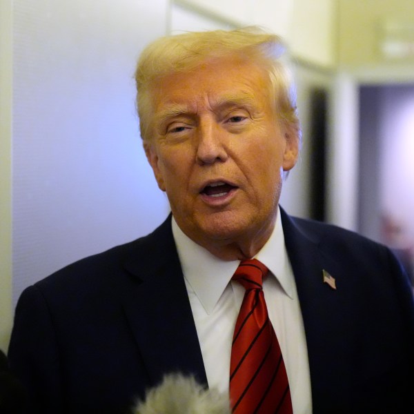 President Donald Trump speaks to reporters aboard Air Force One en route from Miami to Joint Base Andrews, Md., Monday, Jan. 27, 2025. (AP Photo/Mark Schiefelbein)