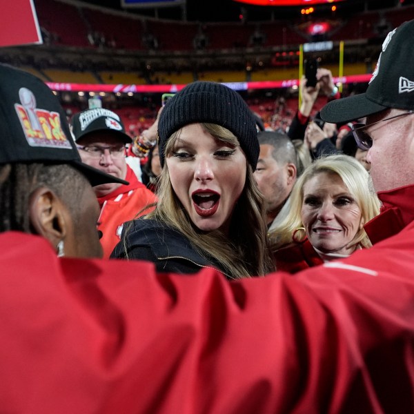 Kansas City Chiefs wide receiver Xavier Worthy, left, and head coach Andy Reid speak with Taylor Swift after the AFC Championship NFL football game against the Buffalo Bills, Sunday, Jan. 26, 2025, in Kansas City, Mo. (AP Photo/Ashley Landis)