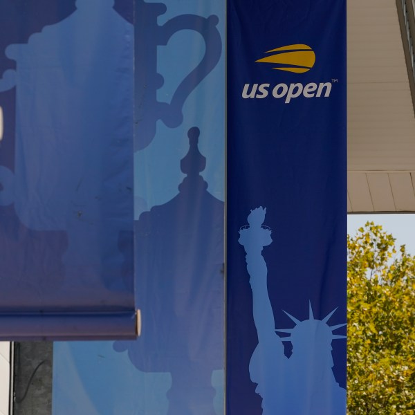 FILE- Banners are displayed on the grounds of the U.S. Open tennis tournament in New York, Thursday, Aug. 25, 2022. (AP Photo/Seth Wenig, File)