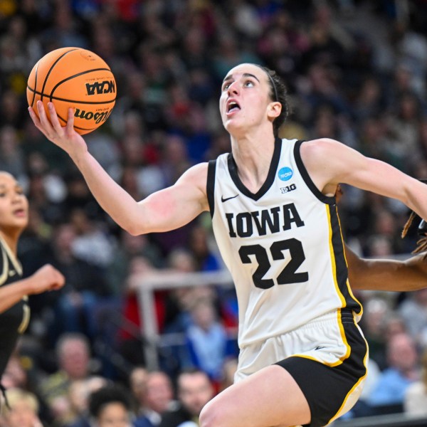 FILE - Iowa guard Caitlin Clark (22) scores against Colorado during the first half of a Sweet 16 college basketball game in the NCAA ournament in Albany, N.Y. Saturday, March 30, 2024. (AP Photo/Hans Pennink, File)