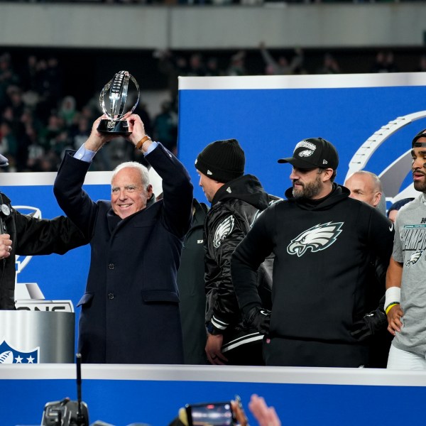 Philadelphia Eagles owner Jeffrey Lurie celebrates with the trophy after their win against the Washington Commanders in the NFC Championship NFL football game, Sunday, Jan. 26, 2025, in Philadelphia. (AP Photo/Chris Szagola)