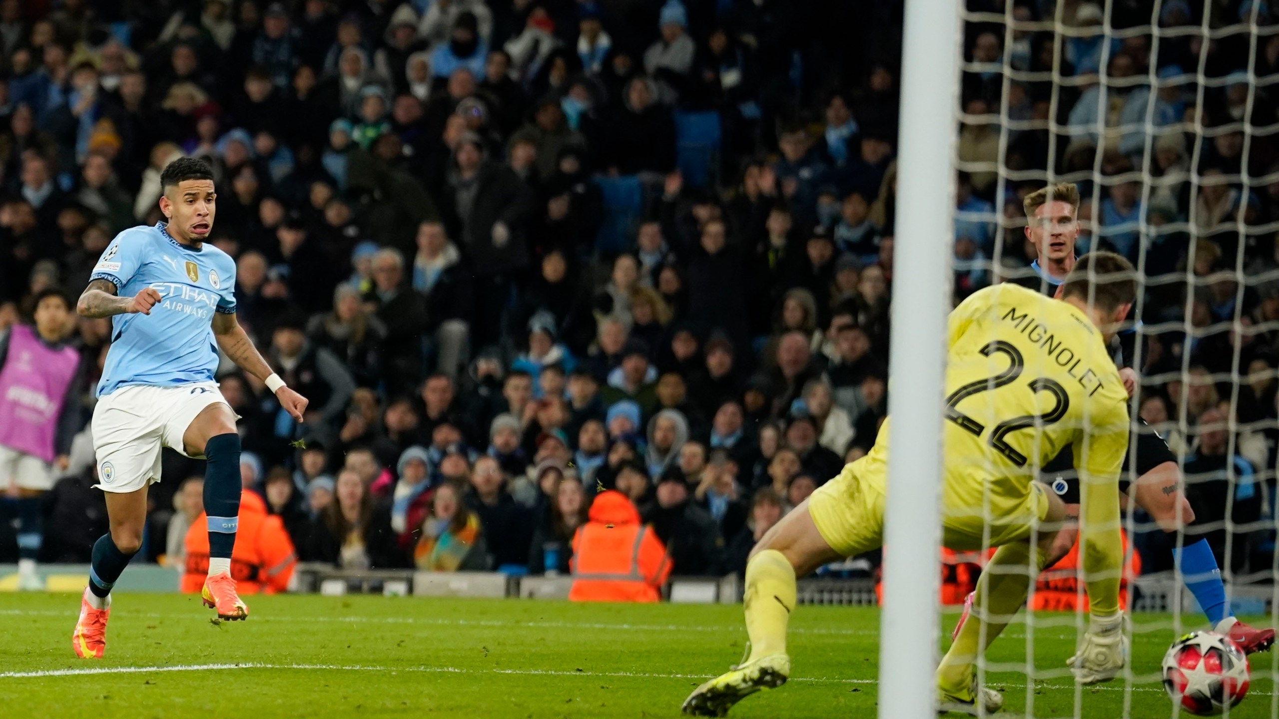 Manchester City's Savinho, left, scores his side's third goal during the Champions League opening phase soccer match between Manchester City and Club Brugge at the Etihad Stadium in Manchester, Wednesday, Jan. 29, 2025. (AP Photo/Dave Thompson)