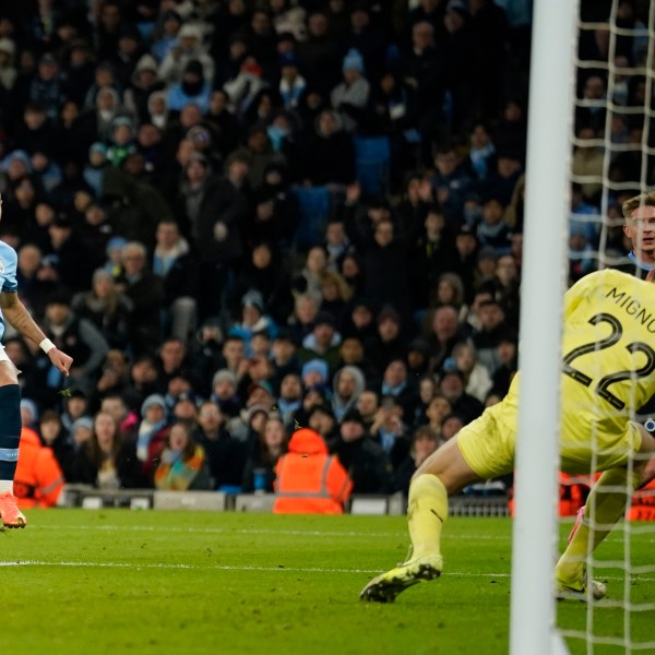 Manchester City's Savinho, left, scores his side's third goal during the Champions League opening phase soccer match between Manchester City and Club Brugge at the Etihad Stadium in Manchester, Wednesday, Jan. 29, 2025. (AP Photo/Dave Thompson)