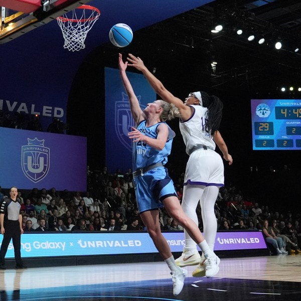 Mist's Courtney Vandersloot (25) aims to score against Lunar Owls' Allisha Gray during the inaugural Unrivaled 3-on-3 basketball game, Friday, Jan. 17, 2025, in Medley, Fla. (AP Photo/Marta Lavandier)