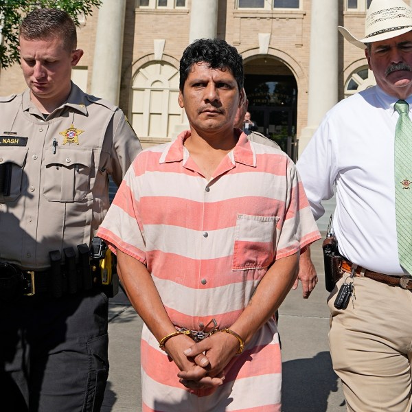 FILE - Francisco Oropeza, center, is escorted from the San Jacinto County courthouse by Sheriff Greg Capers, right, after a hearing May 18, 2023, in Coldspring, Texas. (AP Photo/David J. Phillip, file)