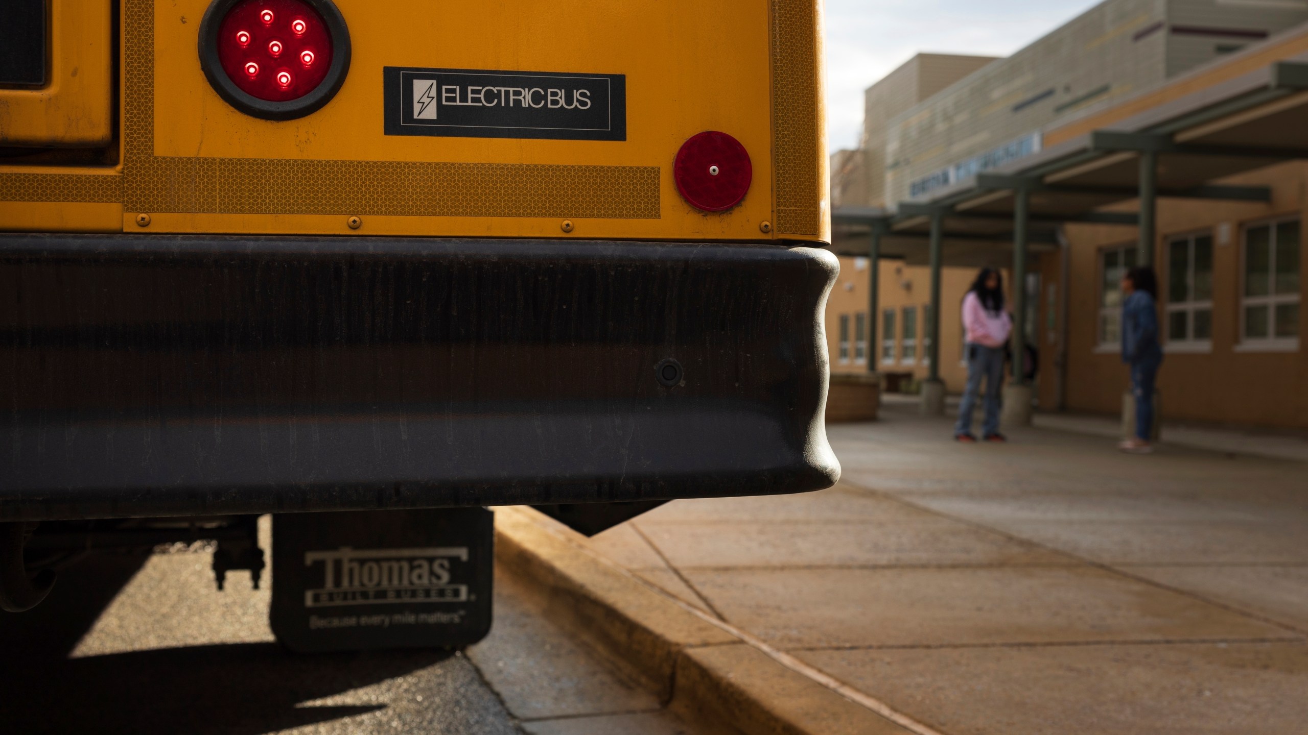 FILE - An electric school bus sits outside Rock Creek Forest Elementary School, Feb. 2, 2024, in Chevy Chase, Md. (AP Photo/Tom Brenner, File)