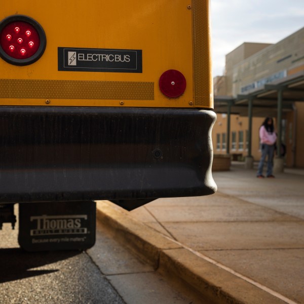 FILE - An electric school bus sits outside Rock Creek Forest Elementary School, Feb. 2, 2024, in Chevy Chase, Md. (AP Photo/Tom Brenner, File)