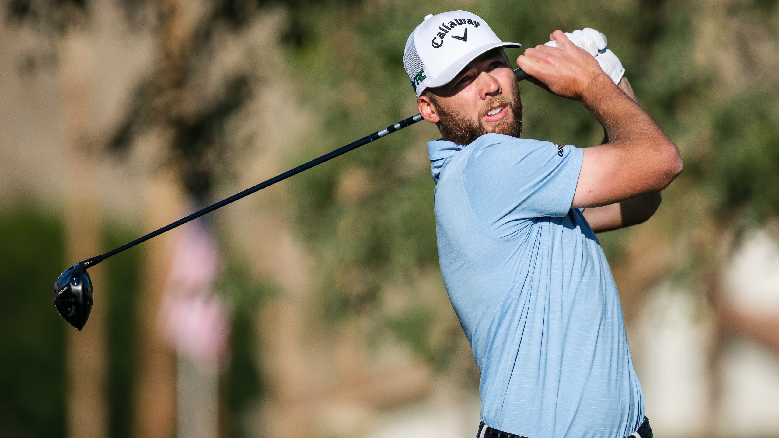 Sam Burns hits from the second tee at La Quinta Country Club Course during the first round of the American Express golf tournament in La Quinta, Calif., Thursday, Jan. 16, 2025. (AP Photo/William Liang)