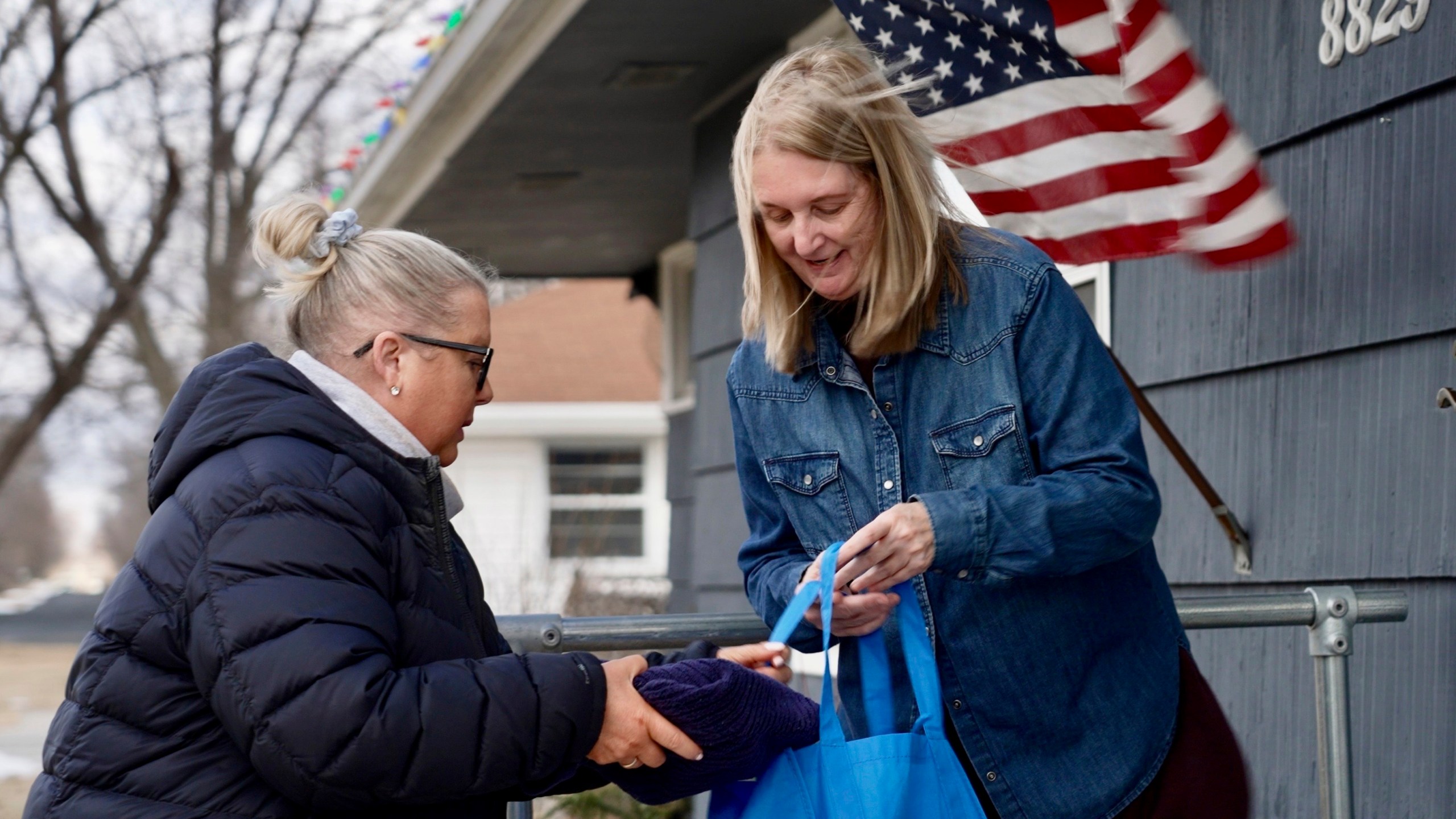 Bloomington and Eden Prairie Meals on Wheels Executive Director Wendy Vossen delivers meals for Barbara Teed and her adult son Ryan, who has Down syndrome, on Wednesday, Jan. 29, 2025, in Bloomington, Minn. (AP photo/Mark Vancleave)