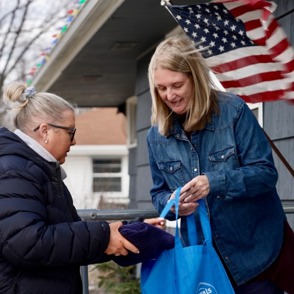 Bloomington and Eden Prairie Meals on Wheels Executive Director Wendy Vossen delivers meals for Barbara Teed and her adult son Ryan, who has Down syndrome, on Wednesday, Jan. 29, 2025, in Bloomington, Minn. (AP photo/Mark Vancleave)