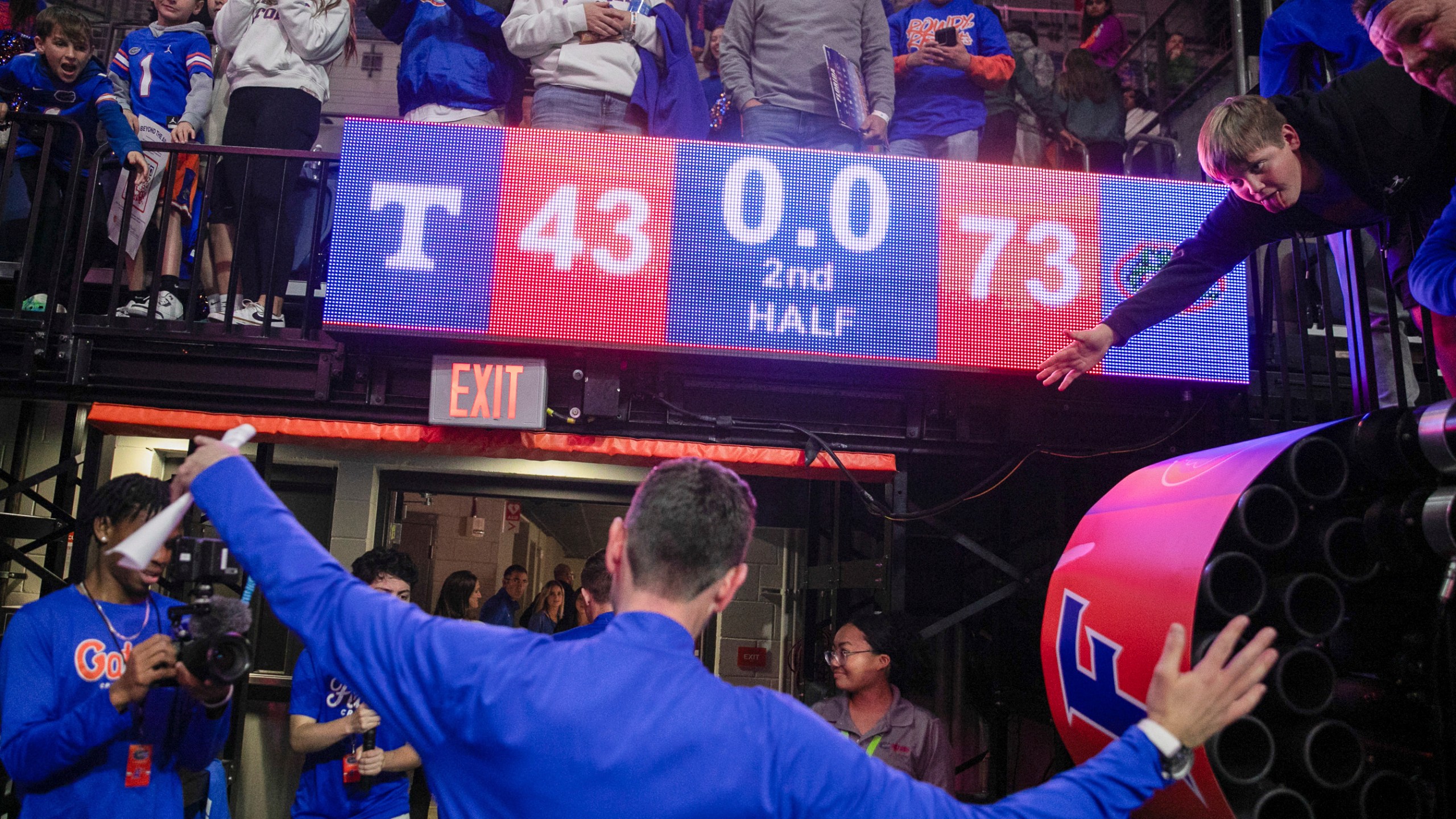 Florida head coach Todd Golden celebrates with fan after defeating Tennessee 73-43 in an NCAA college basketball game Tuesday, Jan. 7, 2025, in Gainesville, Fla. (AP Photo/Alan Youngblood)