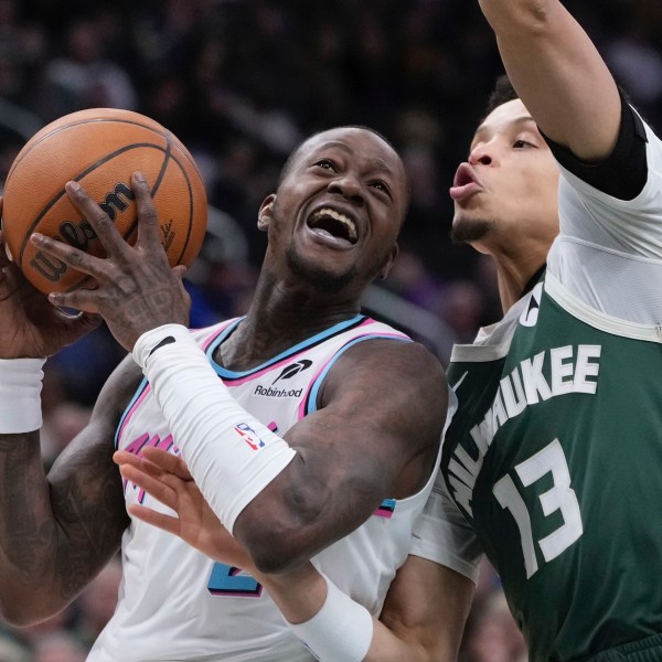 Miami Heat's Terry Rozier tries to get past Milwaukee Bucks' Ryan Rollins during the first half of an NBA basketball game Thursday, Jan. 23, 2025, in Milwaukee. (AP Photo/Morry Gash)