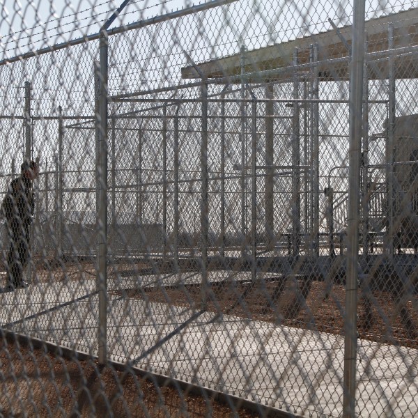 FILE - A Border Patrol agent wait to show reporters an immigration holding facility, Tuesday, Feb. 25, 2020, in El Paso, Texas. (AP Photo/Cedar Attanasio, File)