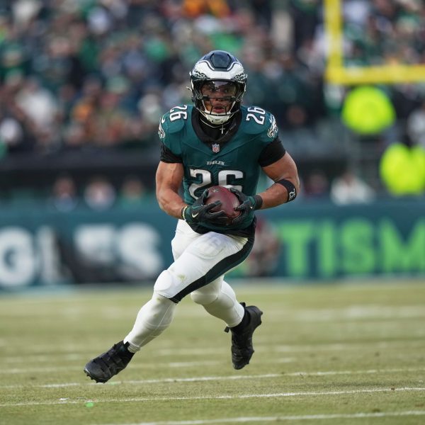 Philadelphia Eagles running back Saquon Barkley rushes for a gain against the Washington Commanders during the first half of the NFC Championship NFL football game, Sunday, Jan. 26, 2025, in Philadelphia. (AP Photo/Matt Slocum)